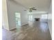 Expansive living space with light walls, modern flooring, and a charming brick fireplace at 3619 Edinburgh Dr, Las Vegas, NV 89103