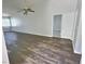 Bright living area featuring wood-look flooring, neutral paint, a ceiling fan, and natural light from windows at 3619 Edinburgh Dr, Las Vegas, NV 89103