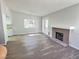 Bright living room features a brick fireplace, wood floors and natural light at 3619 Edinburgh Dr, Las Vegas, NV 89103