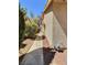 Exterior shot shows a narrow side yard with tan stucco wall and a glimpse of neighboring rooftops at 3619 Edinburgh Dr, Las Vegas, NV 89103