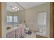 Bathroom featuring a large mirror, ample lighting, and a soaking tub near a window at 364 Wild Plum Ln, Las Vegas, NV 89107