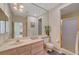 Bathroom with white cabinets, a large mirror, neutral tile, a shower, and separated toilet at 364 Wild Plum Ln, Las Vegas, NV 89107