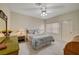 Bedroom boasts carpet flooring, a ceiling fan, and natural light from a large window at 364 Wild Plum Ln, Las Vegas, NV 89107
