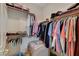 Spacious walk-in closet with clothes hanging, shelves for shoes, and an armchair for convenience at 364 Wild Plum Ln, Las Vegas, NV 89107