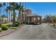 View of the community's secure entrance gate, surrounded by palm trees and well-kept grounds at 364 Wild Plum Ln, Las Vegas, NV 89107