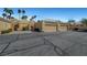 Single-story home with garages and desert landscaping in a well-maintained community at 364 Wild Plum Ln, Las Vegas, NV 89107