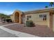 Charming single-story home with desert landscaping, an arched entry, and wrought iron gate at 364 Wild Plum Ln, Las Vegas, NV 89107