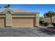 Single-car garage with a beige door, desert landscaping, and a well-maintained exterior at 364 Wild Plum Ln, Las Vegas, NV 89107