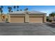 Two-car garage with beige doors and plenty of parking space in front of the property at 364 Wild Plum Ln, Las Vegas, NV 89107