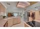 Bright kitchen boasts modern appliances, light wood cabinets, sleek countertops and an adjoining dining area at 364 Wild Plum Ln, Las Vegas, NV 89107