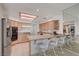 Well-lit kitchen featuring stainless steel appliances, breakfast bar, and tile flooring at 364 Wild Plum Ln, Las Vegas, NV 89107