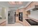 Charming kitchen with stainless steel refrigerator, modern appliances, and light wood cabinetry for a timeless appeal at 364 Wild Plum Ln, Las Vegas, NV 89107