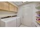 Laundry room with washer, dryer, and shelves for storage and tile flooring at 364 Wild Plum Ln, Las Vegas, NV 89107