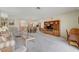 Bright living room with open layout to the kitchen, carpet flooring and built-in shelving at 364 Wild Plum Ln, Las Vegas, NV 89107