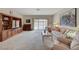 Cozy living room with neutral carpet, a large built-in, and a sliding glass door to the patio at 364 Wild Plum Ln, Las Vegas, NV 89107