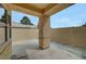 Covered patio area with textured stucco walls and gravel landscaping provides a private outdoor space at 364 Wild Plum Ln, Las Vegas, NV 89107