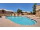 Community pool and sundeck with lounge chairs, surrounded by mature landscaping at 364 Wild Plum Ln, Las Vegas, NV 89107