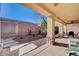 Covered patio with stone supports overlooks the low-maintenance backyard at 3663 Coventry Gardens Dr, Las Vegas, NV 89135