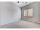 Bedroom with plush carpet, ceiling fan, and a window with white shutter blinds at 3663 Coventry Gardens Dr, Las Vegas, NV 89135