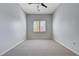 Bright bedroom featuring neutral carpet, ceiling fan, and window with shutter-style blinds at 3663 Coventry Gardens Dr, Las Vegas, NV 89135