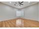 Bright bedroom with hardwood floors, ceiling fan, and bay window with shutters at 3663 Coventry Gardens Dr, Las Vegas, NV 89135