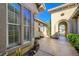 A house entrance with a secure gate, complemented by vibrant floral arrangements and a well-maintained walkway at 3663 Coventry Gardens Dr, Las Vegas, NV 89135