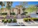 Charming single-story home featuring a landscaped front yard with stone accents and a welcoming arched entryway at 3663 Coventry Gardens Dr, Las Vegas, NV 89135