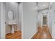 Hallway with hardwood floors, leading to pedestal sink in alcove at 3663 Coventry Gardens Dr, Las Vegas, NV 89135