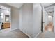 Hallway with wood floors leading to neutral carpeted bedroom with bathroom access at 3663 Coventry Gardens Dr, Las Vegas, NV 89135