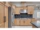 Well-equipped kitchen boasts stainless steel appliances, wood cabinets, and sleek countertops at 3663 Coventry Gardens Dr, Las Vegas, NV 89135