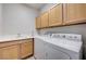 Bright laundry room with a sink, counter, and washer and dryer set at 3663 Coventry Gardens Dr, Las Vegas, NV 89135