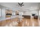Open floor plan with living room, kitchen, hardwood floors, and natural light, perfect for entertaining and modern living at 3663 Coventry Gardens Dr, Las Vegas, NV 89135