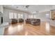 Open concept living space with hardwood floors, ceiling fans, and natural light, creating an airy, inviting atmosphere at 3663 Coventry Gardens Dr, Las Vegas, NV 89135