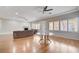 Expansive living area with hardwood floors, fireplace, ceiling fans, and ample natural light, ideal for gatherings at 3663 Coventry Gardens Dr, Las Vegas, NV 89135