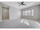 Spacious main bedroom featuring plush carpeting, ceiling fan, and natural light from window with shutters at 3663 Coventry Gardens Dr, Las Vegas, NV 89135