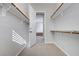 Walk-in closet with wood rods and shelving, providing ample storage and organization at 3663 Coventry Gardens Dr, Las Vegas, NV 89135