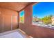 Enclosed balcony with serene views of the neighborhood and a glimpse of the street at 3920 Legend Hills St # 202, Las Vegas, NV 89129