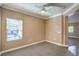 Bedroom with natural light, a ceiling fan, and neutral colored walls and carpet at 3920 Legend Hills St # 202, Las Vegas, NV 89129