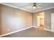 Spacious bedroom featuring neutral walls, plush carpet, and a ceiling fan at 3920 Legend Hills St # 202, Las Vegas, NV 89129