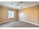 Neutral toned bedroom with a ceiling fan, a window, and neutral carpet at 3920 Legend Hills St # 202, Las Vegas, NV 89129
