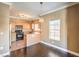 Bright dining area features dark wood floors, chandelier, and stainless steel appliances at 3920 Legend Hills St # 202, Las Vegas, NV 89129