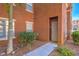 Condo front entry featuring rock landscaping and secured front door at 3920 Legend Hills St # 202, Las Vegas, NV 89129