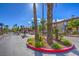 Community entrance with palm trees and well-maintained landscaping at 3920 Legend Hills St # 202, Las Vegas, NV 89129