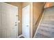 Bright entryway with carpeted staircase and white doors leading to the living space at 3920 Legend Hills St # 202, Las Vegas, NV 89129