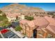 Well-maintained exterior of multi-Gathering unit with covered parking, a mountain backdrop and assigned parking spaces at 3920 Legend Hills St # 202, Las Vegas, NV 89129