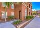 Condo exterior showcasing lush landscaping, sidewalk, and well-lit entryway at 3920 Legend Hills St # 202, Las Vegas, NV 89129