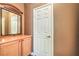 Hallway area features a mirrored dresser set against neutral tan walls with a white passage door at 3920 Legend Hills St # 202, Las Vegas, NV 89129