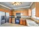 Bright kitchen with stainless steel refrigerator, light wood cabinets, and tile floors at 3920 Legend Hills St # 202, Las Vegas, NV 89129