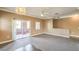 Open living room with sliding glass doors for access to a private balcony and neutral color palette at 3920 Legend Hills St # 202, Las Vegas, NV 89129