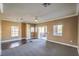 Spacious living room with new carpeting, base board trim, and a sliding door to balcony at 3920 Legend Hills St # 202, Las Vegas, NV 89129